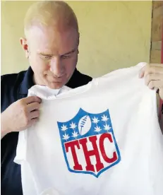  ?? E d A n d r i e s k i / t h e ass o c i at e d p r e ss ?? Bryan Weinman shows off one of his “Stoner Bowl” T-shirts. It replaces “NFL” in the league’s logo with the letters “THC.”