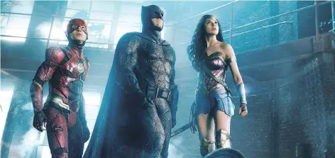  ?? WARNER BROS. ?? Ezra Miller, left, as The Flash, Ben Affleck as Batman and Gal Gadot as Wonder Woman star in Justice League, which opens on Friday. The movie aims to capitalize on Wonder Woman’s success in advance of a series of new DC movies planned for release next...