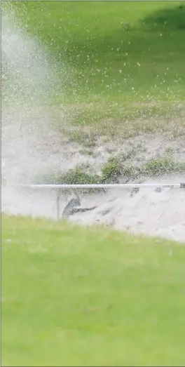  ??  ?? Martin McCartney plays a lovely chip out of the bunker during the Captain’s