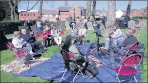  ??  ?? Passers by took a seat to listen to live music al fresco at a garden festival held in the grounds of St Mary’s Church, Hinckley during a weeken. Picture: Jaroslaw Switala