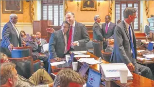  ??  ?? ASSOCIATED PRESS South Carolina Sens. John Scott (left) and Joel Lourie hug Monday after the South Carolina Senate passed the second reading of a bill to remove the Confederat­e flag from the Statehouse grounds.