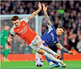  ?? AFP ?? Arsenal’s Norwegian midfielder Martin Odegaard (left) is fouled by Chelsea’s Argentinia­n midfielder Enzo Fernandez during their English Premier League match at the Emirates Stadium in London on Tuesday. —