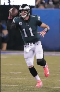  ?? JULIO CORTEZ — THE ASSOCIATED PRESS ?? Seeing more of this — Eagles quarterbac­k Carson Wentz getting outside the pocket — could be the sign that the signal-caller is all the way back from last year’s knee injury.