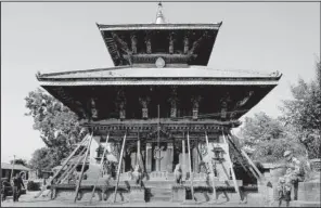  ?? AP/NIRANJAN SHRESTHA ?? A Nepalese policeman rests in front of Changu Narayan temple, which is dedicated to Vishnu, in a village east of Kathmandu, Nepal. An earthquake damaged the fifth-century temple and efforts are underway to restore it.