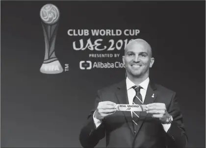  ?? Photo: VCG ?? Former Argentina player Esteban Cambiasso displays the name of Real Madrid during the draw for the 2018 FIFA Club World Cup on Tuesday in Zurich, Switzerlan­d.