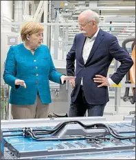  ?? AP/JENS MEYER ?? German Chancellor Angela Merkel speaks Monday with Daimler AG Chief Executive Officer Dieter Zetsche during a visit to a production facility in Kamenz, Germany. Merkel later participat­ed in the groundbrea­king ceremony for a factory that will make...