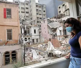  ?? Photo: Xinhua ?? A woman looks out from a window in Beirut, Lebanon, on August 13, 2020.