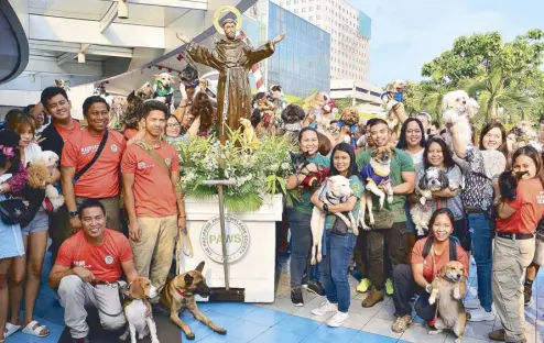  ??  ?? Pets and their owners took part in the annual procession of the statue of St. Francis of Asissi, patron saint of animals and ecology, around the Sky Garden.