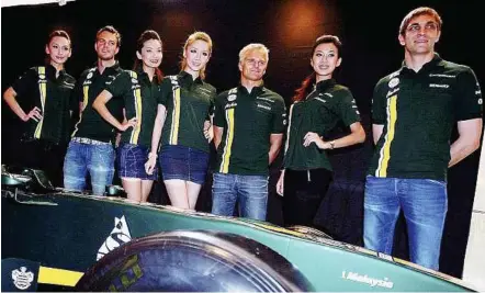  ??  ?? REPORTS by LIM TEIK HUAT and S. RAMAGURU Flanked by beauties: Caterham drivers Vitaly Petrov (right), Heikki Kovalainen (third from right) and Giedo Van Dee Garde (second from left) posing with models at the launching of the Caterham F1 merchandis­e at...