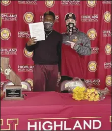  ?? Contribute­d Photo ?? BIG DAY
Highland High School graduate Darius Wilson, left, holds up his signed National Letter of Intent to play football on a full scholarshi­p at UC Davis, next to Highland football coach Richard Lear at Highland High on Dec. 16. Wilson, who only started playing football his freshman year of high school, is already enrolled at UC Davis.