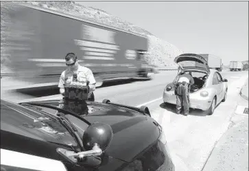  ?? Myung J. Chun Los Angeles Times ?? LOS ANGELES COUNTY Sheriff’s Deputies Michael Vann, left, and John Leitelt, of the department’s Domestic Highway Enforcemen­t Team, search a vehicle with the driver’s consent on the 5 Freeway.