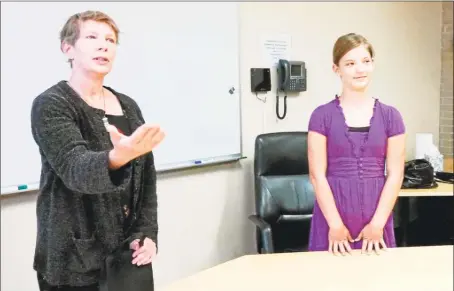  ?? Hearst Connecticu­t Media file photo ?? Middletown poet laureate Susan Allison, left, recites her poem, “Rapallo Avenue,” during her inaugurati­on, as former Keigwin Middle School student Sasha Zipf looks on.