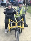  ?? (Pic: EOB-d) ?? Mary Irwin from Mitchelsto­wn (left) and Coláiste an Chraoibhín TY student Sam Twomey, trying out a sideby-side bike on Wednesday, as part of Bike Week 2023.