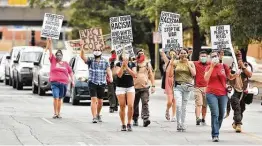  ?? Robin Jerstad / Contributo­r ?? Marchers lead a caravan during a National Day of Protest against evictions, foreclosur­es, police brutality and racism recently in downtown San Antonio.