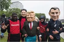  ?? CP PHOTO ?? Activists stage a demonstrat­ion while wearing masks of G7 leaders, from left, Justin Trudeau, Donald Trump, Theresa May and Emmanuel Macron prior to the G7 Summit in Quebec City on Thursday.