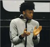  ?? EZRA SHAW — GETTY IMAGES ?? The Warriors’ James Wiseman stands on the bench during their preseason game against the Kings at Golden 1 Center on Tuesday in Sacramento.