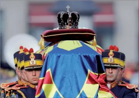  ?? VADIM GHIRDA — THE ASSOCIATED PRESS ?? Honor guard soldiers carry the coffin of the late Romanian King Michael during the funeral ceremony outside the former royal palace in Bucharest, Romania, on Saturday. Thousands waited in line to pay their respects to the former king, who ruled Romania...