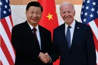  ?? — AP ?? Chinese President Xi Jinping greets US President Joe Biden before their meeting on the sidelines of the G20 summit on Monday.