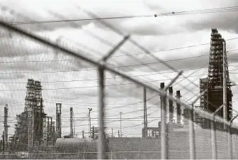  ?? Callaghan O'Hare / Bloomberg ?? A security fence stands in front of the Motiva Enterprise­s LLC Refinery in Port Arthur. Oil and chemical facilities located along the Texas Gulf Coast are shuttering ahead of the hurricane.