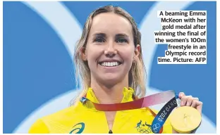  ??  ?? A beaming Emma McKeon with her gold medal after winning the final of the women’s 100m freestyle in an Olympic record time. Picture: AFP