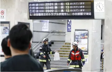  ??  ?? Rescue workers are seen at Odawara station after a Japanese Shinkansen bullet train made an emergency stop on its way from Tokyo to the western city of Osaka due to a man holding an edged tool attacked passengers, in Odawara, west of Tokyo, Japan.