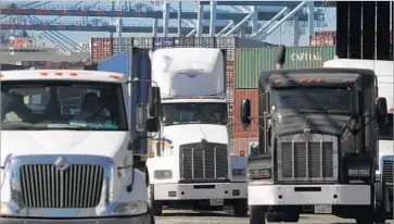  ?? Bob Chamberlin Los Angeles Times ?? THE VAST MAJORITY of the 12,000 regular truck drivers at the L.A. and Long Beach ports are classified as independen­t contractor­s. But judges and regulators have consistent­ly ruled they’re employees in all but name.