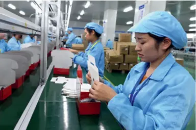  ?? ?? Women work on a mobile phone production line at a company in Liancheng County, Fujian Province, on November 6, 2020. From September to November that year, the county introduced more than 100 positions with flexible working hours to help local mothers balance work and family
