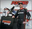  ?? AP PHOTO/MATT SLOCUM ?? Will Power poses with the trophy after winning an IndyCar Series auto race at Pocono Raceway on Sunday in Long Pond, Pa.