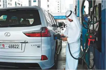  ?? Abdul Rahman/Gulf News ?? A customer refuelling his vehicle at an Adnoc petrol station on Salam Street in Abu Dhabi yesterday. The premium service fee will be charged at Adnoc stations in Abu Dhabi first.