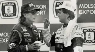  ?? KEN FAUGHT/TORONTO STAR FILE PHOTO ?? Emmerson Fittipaldi, left, who won the race in 1987, listens as Michael Andretti explains why they collided during the 1989 Toronto Indy, which was the first of Andretti’s seven victories.