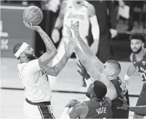  ?? MARK J. TERRILL AP ?? Lakers forward Anthony Davis (left) attempts a shot over Denver’s Nikola Jokic.