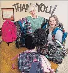  ?? JULIE JOCSAK THE ST. CATHARINES STANDARD ?? Chrissy Sadowski, fund developmen­t officer, left, and Rhiannon Fleming, communicat­ions and special events co-ordinator at Community Care of St. Catharines, display some of the backpacks.