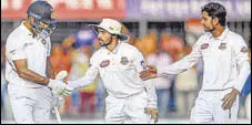  ?? AFP ?? Bangladesh players congratula­te Mayank Agarwal after his double ton during the first Test in Indore.