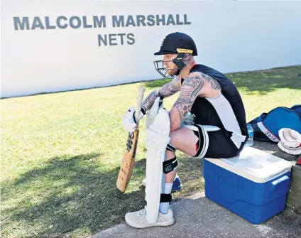  ??  ?? Turning back time: Ben Stokes (above) in front of nets named after Malcolm Marshall (inset). He is buried on the south coast of Barbados (left)