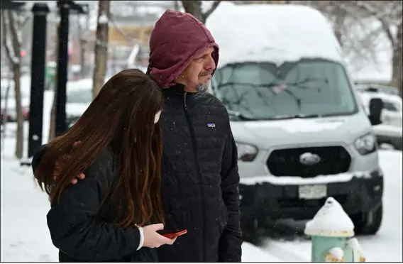  ?? HELEN H. RICHARDSON — THE DENVER POST ?? Jim Moscou and daughter Leah wait for news of his son and Leah’s brother, Austin, who was still inside the school at Boulder High School on Wednesday in Boulder. “I am sick of this happening,” said Moscou, who arrived outside the school the moment he heard about a potential shooter in the area. Leah is a freshman at Boulder High School but wasn’t at school yet because of a delayed start to the school day.