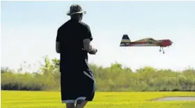  ?? LLOYD FOX/BALTIMORE SUN ?? Adam Hales of Linthicum flies his Yak 54 remote-controlled plane at the Southwest Area Park. Pilots will gather at the park today for an air show put on by a Baltimore County club.