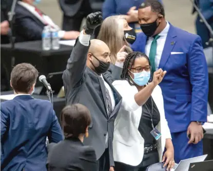  ?? AP ?? State Rep. Justin Slaughter, D-Chicago, holds up his fist Jan. 13 after a criminal justice reform bill passed in the Illinois House.