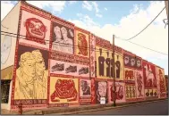  ??  ?? At 321 S. Main St. in Stuttgart, South African artist Keya Tama’s OZ Art ARkanvas mural includes 17 scenes.