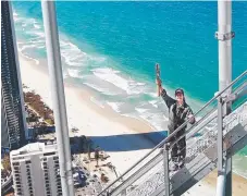  ??  ?? Olympic silver medallist Brittany Broben carries the Baton to the top of the Q1 tower, the highest point of the Australian leg.