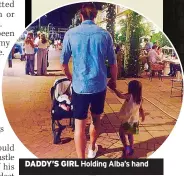  ??  ?? DADDY’S GIRL Holding Alba’s hand