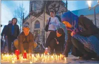  ?? AP PHOTO ?? People light candles during a memorial service in front of the Muenster, western Germany, cathedral Sunday, April 8, 2018, one day after a man killed two people and injured 20 others by crashing into people drinking outside a popular bar before killing...