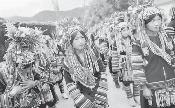  ??  ?? Ethnic Akha women march during a festival in a village outside Pansang, Wa territory in north east Myanmar. — Reuters photo