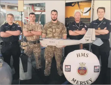  ??  ?? WORKING HARD The team on HMS Mersey after a week of trials testing new drone tech