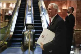  ?? CAROLYN KASTER, THE ASSOCIATED PRESS ?? U.S> vice president-elect Mike Pence carries a briefing binder as he arrives at Trump Tower, Tuesday in New York.