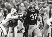  ?? Harry Cabluck / Associated Press 1972 ?? Steelers running back Franco Harris eludes the Raiders’ Jimmy Ware after the “Immaculate Reception.”