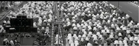  ??  ?? Muslim perform Eid al-fitr prayer marking the end of the holy fasting month of Ramadan on a street in in Bekasi , West Java, yesterday