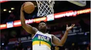  ?? AP PHOTO BY MATTHEW HINTON ?? In this Feb. 13, 2020, file photo, New Orleans Pelicans forward Zion Williamson grabs a rebound during the first half of an NBA basketball game against the Oklahoma City Thunder in New Orleans.