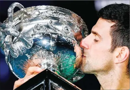  ?? WILLIAM WEST/AFP ?? Serbia’s Novak Djokovic kisses the Norman Brookes Challenge Cup trophy following his victory against Russia’s Daniil Medvedev in their men’s singles final match of the Australian Open tennis tournament in Melbourne on Sunday.