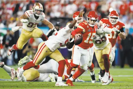  ?? Scott Strazzante / The Chronicle ?? Mahomes scrambles away from the 49ers’ defense in the fourth quarter. After he was intercepte­d for a second time, Mahomes went 8for12 for 114 yards and two touchdowns to spearhead a Chiefs comeback that produced their first title in 50 years.