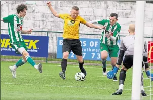  ?? Pictures: Andy Jones FM31020647, left; FM31020647, right ?? Left, Kennington are thwarted by the Rusthall keeper at Homelands on Saturday. Right, Craig Calvert bears down on the Rusthall goal